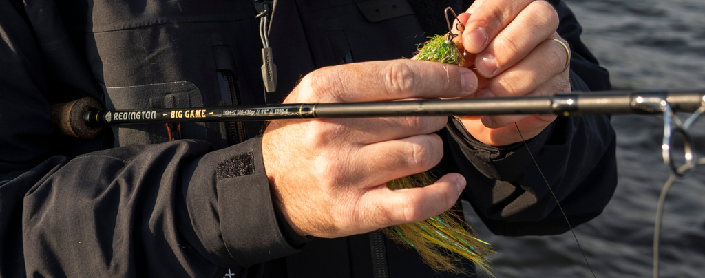 Close up of Big game rod with large fly being tied on