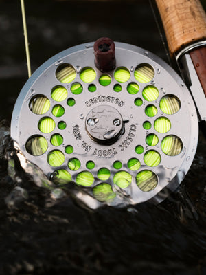 Redington Classic Trout Reel in silver dunking into the water