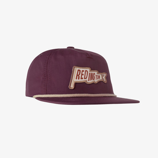 A structured nylon fishing cap with an eggplant color, featuring a Redington fish flag graphic and a snap-back closure.