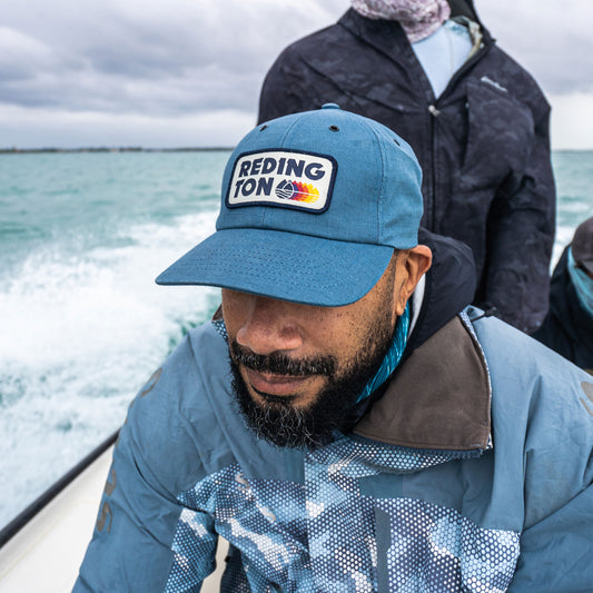 Image of an angler wearing the Fade Away hat.